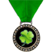 Green game play medal award with four leaf clover